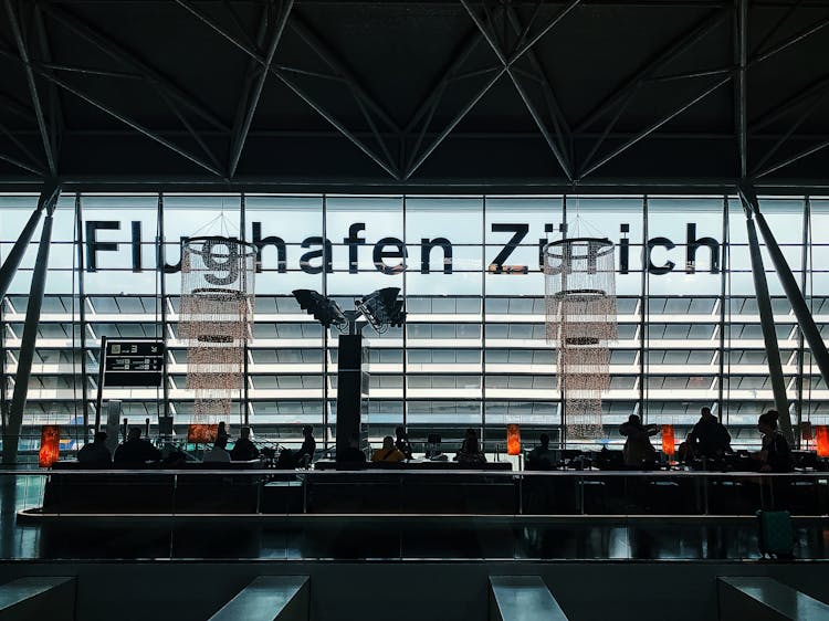 Silhouette Of People Sitting In Airport Waiting Area