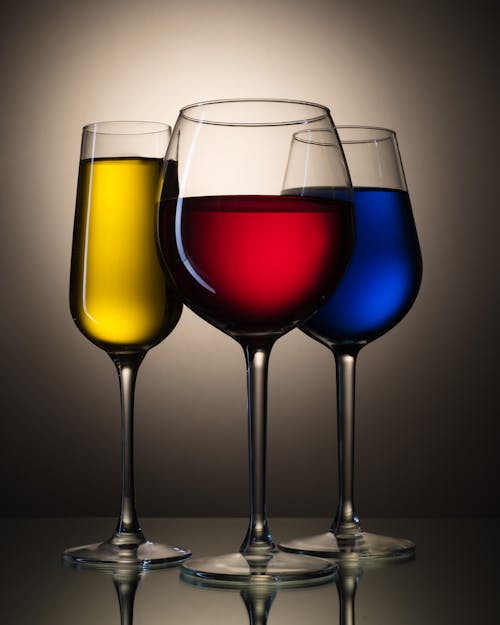 Different Types of Bar Glasses with Colored Liquids