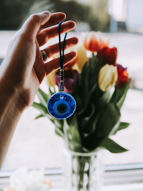 Free A Person Holding a Blue Amulet Stock Photo