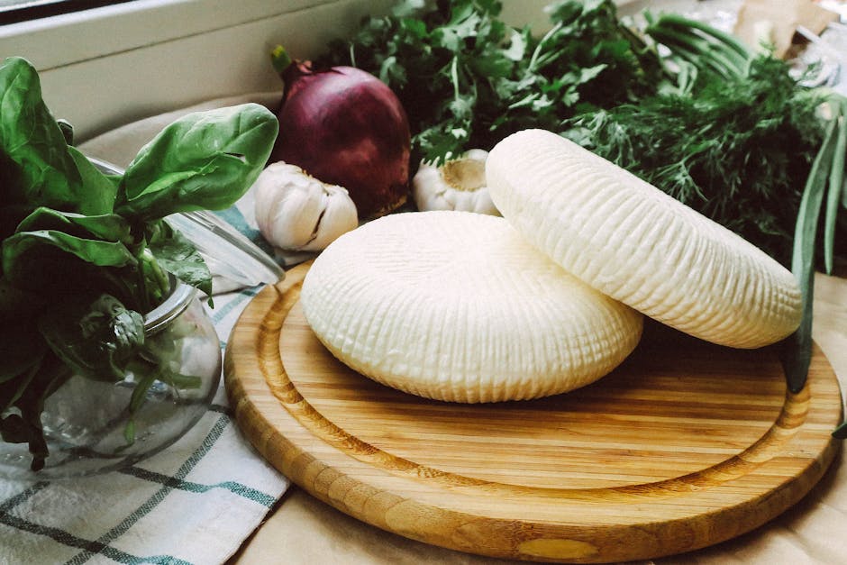 fresh ricotta cheese, garlic bulbs, and lemon on a wooden board - garlic ricotta pasta fresh ricotta cheese, garlic bulbs, and lemon on a wooden board - garlic ricotta pasta