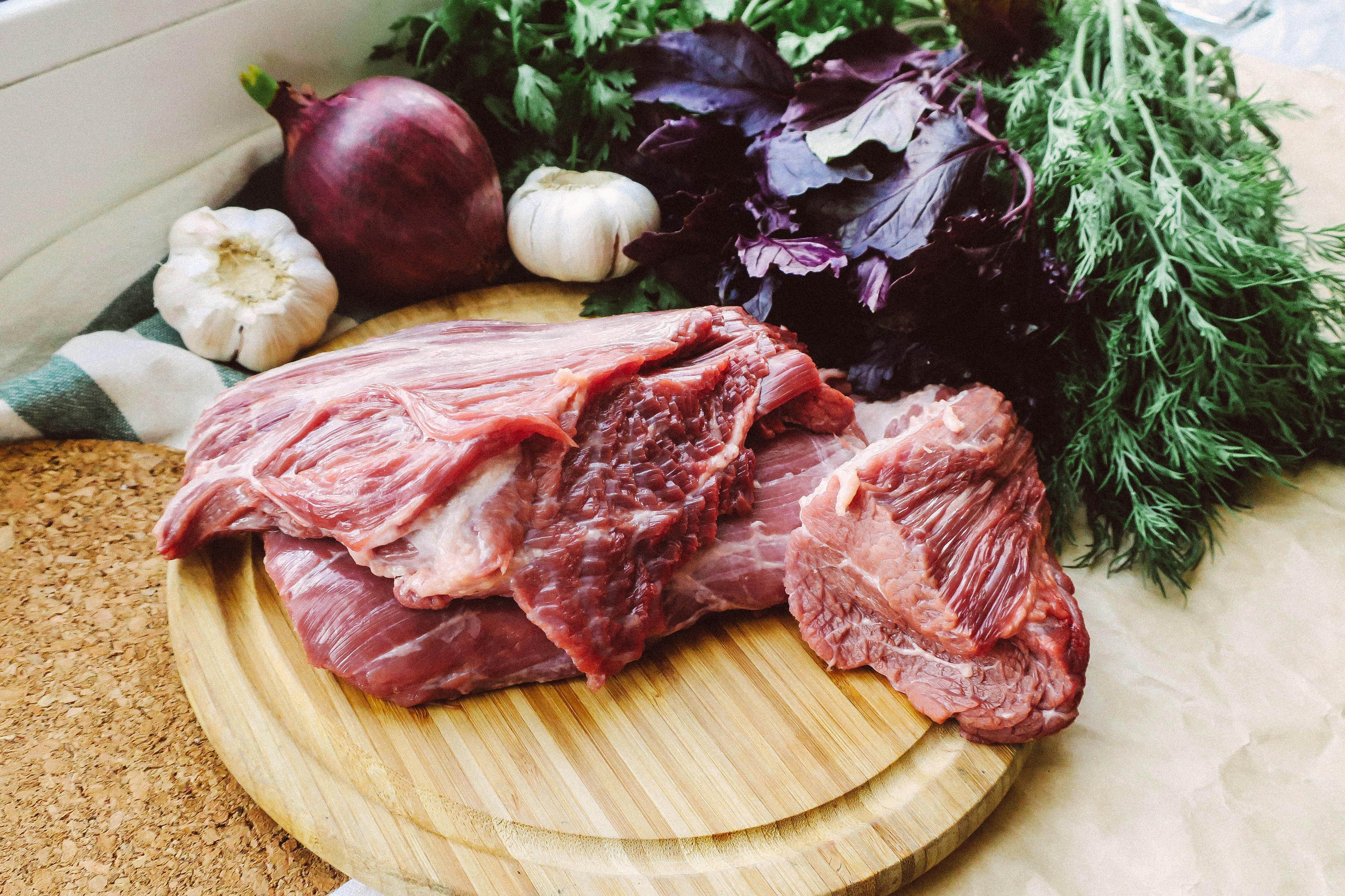 Free Raw Beef Slices on Wooden Chopping Board Stock Photo