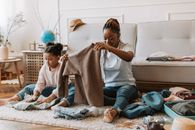 Woman and Child Holding Clothes Together