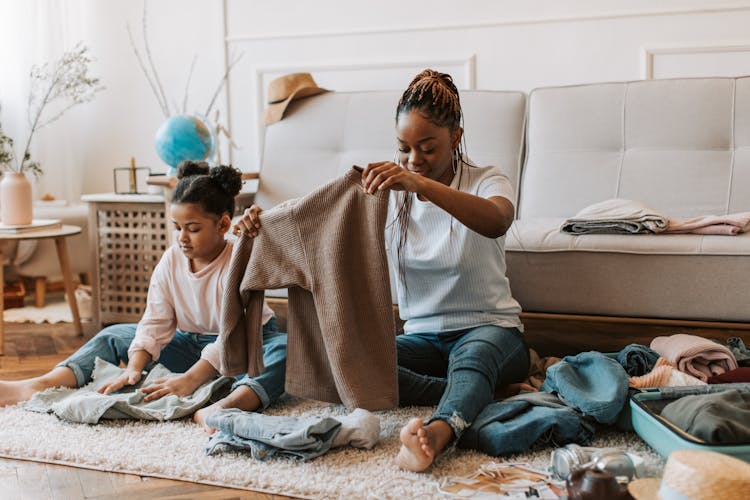 Woman And Child Holding Clothes Together