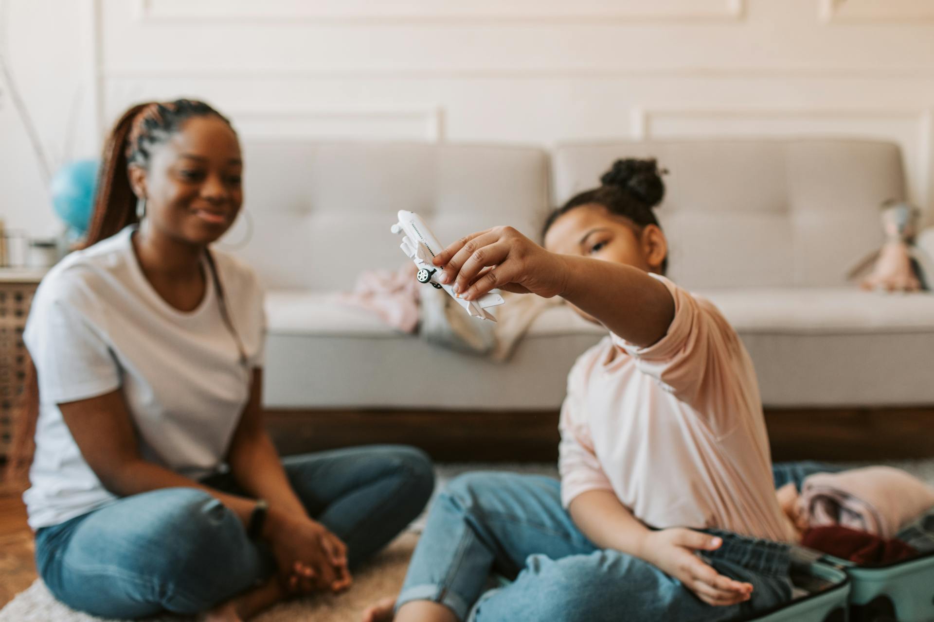 Mother and Daughter Looking at a Toy