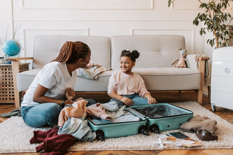 Mother And Daughter Packing Clothes 