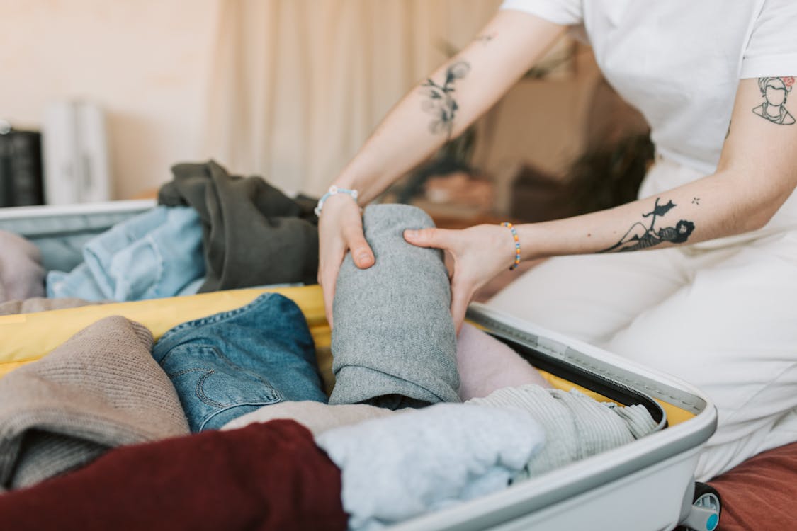 Free Person Packing Their Luggage Stock Photo