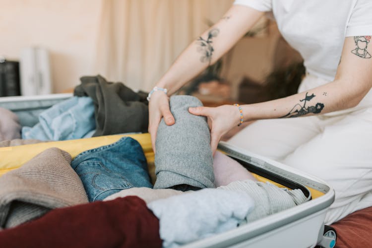 Person Packing Their Luggage