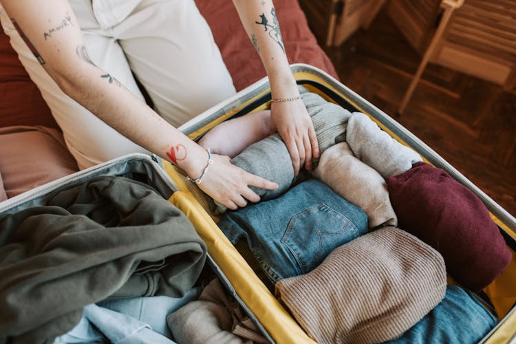 Person Packing A Luggage 