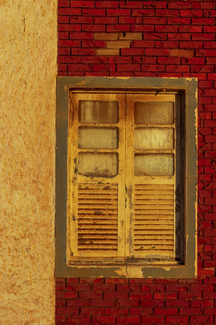 Window With Shutters On Brick Wall