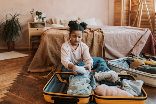 Free Child Packing a Luggage in Her Bedroom Stock Photo