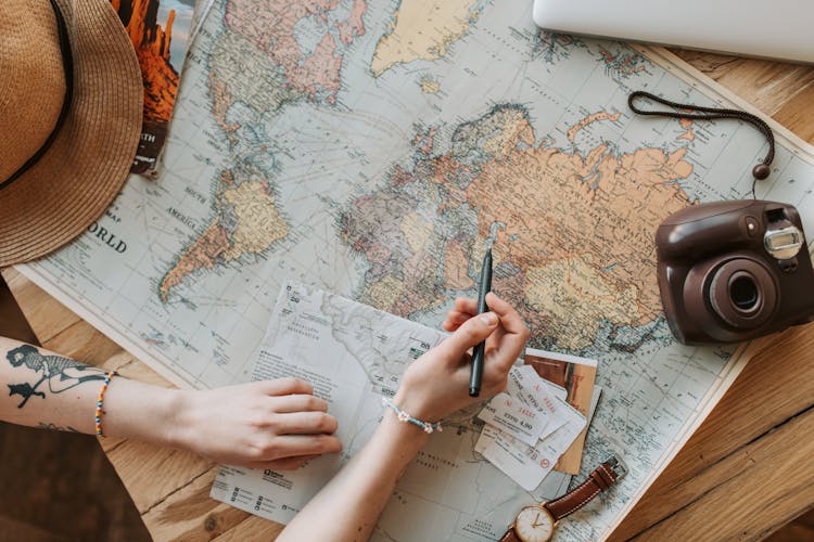 Woman Looking At A Map With A Pen In Her Hand 