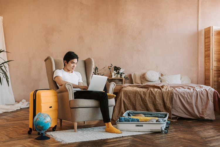 A Man Using Laptop While Sitting On The Sofa