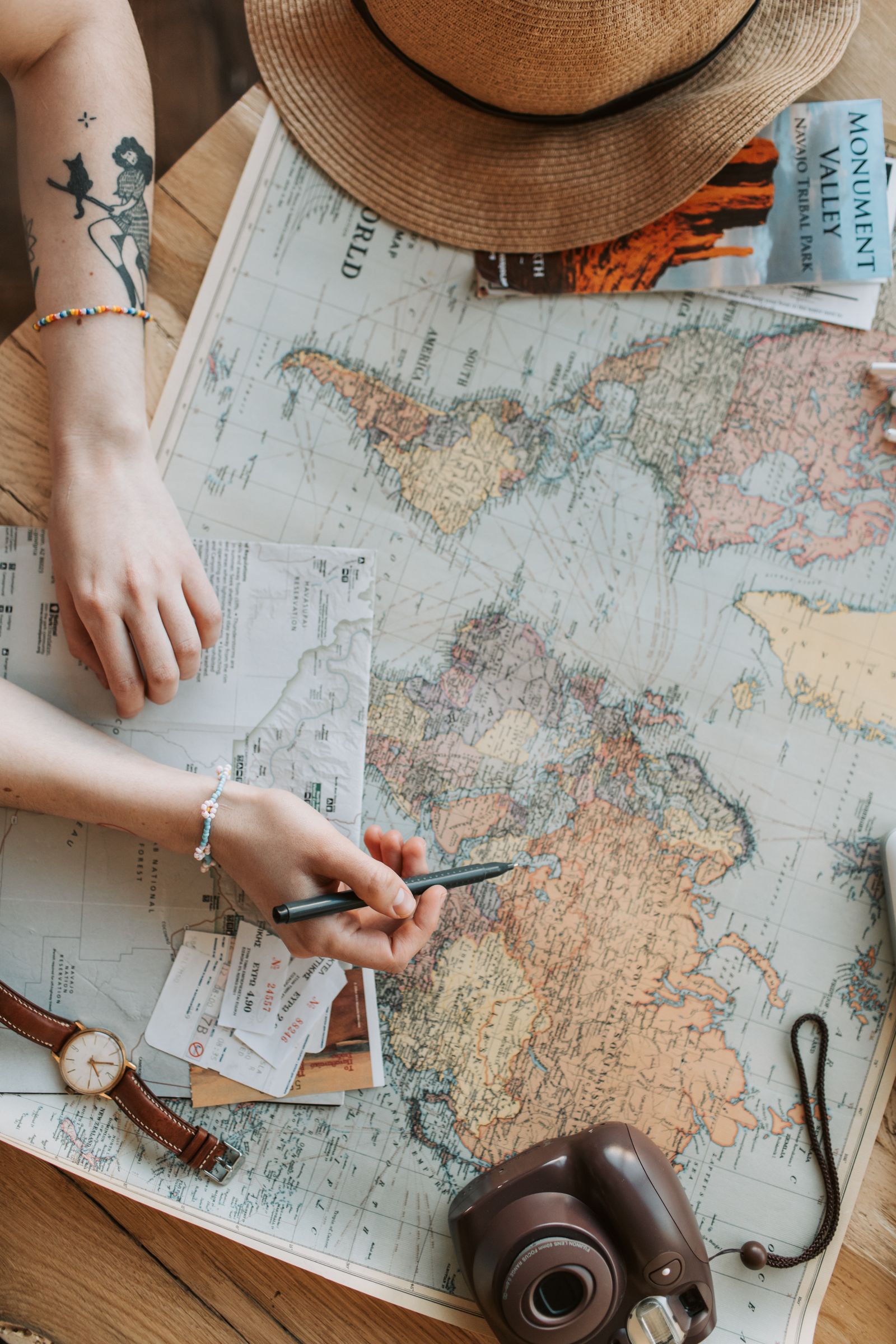 Traveller marking a map while keeping belongings organised