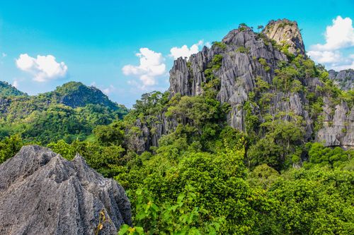Free Explore this breathtaking rocky mountain landscape, surrounded by lush greenery and vivid blue skies. Stock Photo