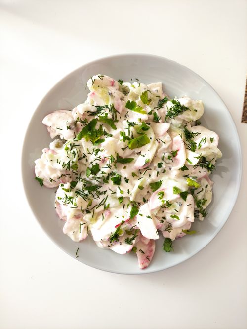 Free A fresh and creamy radish salad garnished with herbs provides a healthy and delicious meal. Stock Photo