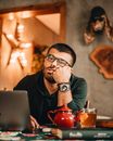 Bored man at table with laptop in cafe