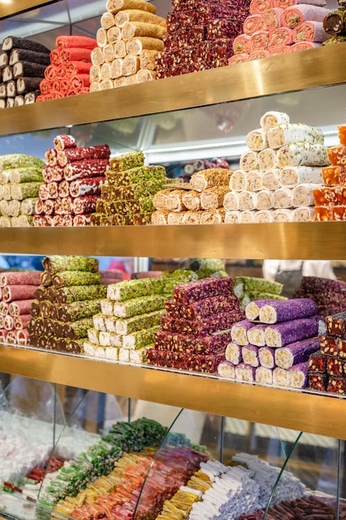 Assorted sweet Turkish delights on shelves in shop