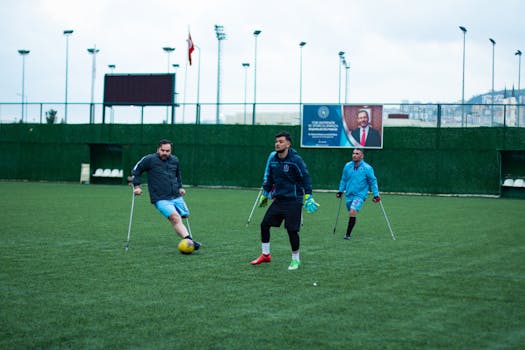 Adaptive athletes playing soccer on a field, showing skill and determination.