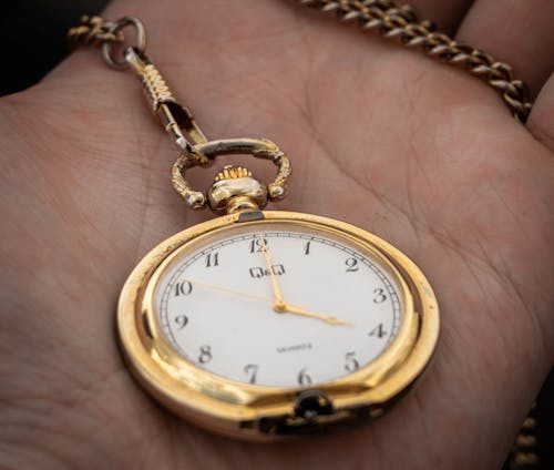 Free A person Holding a Clock Stock Photo