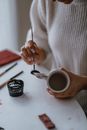 Person Holding White Ceramic Mug
