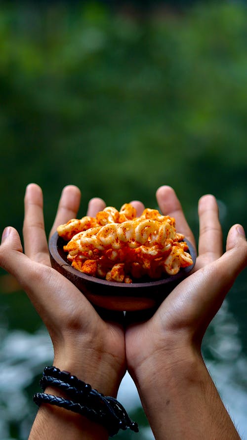 A Saucer with Food on a Person's Hands