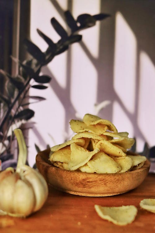 A Potato Chips on a Wooden Bowl