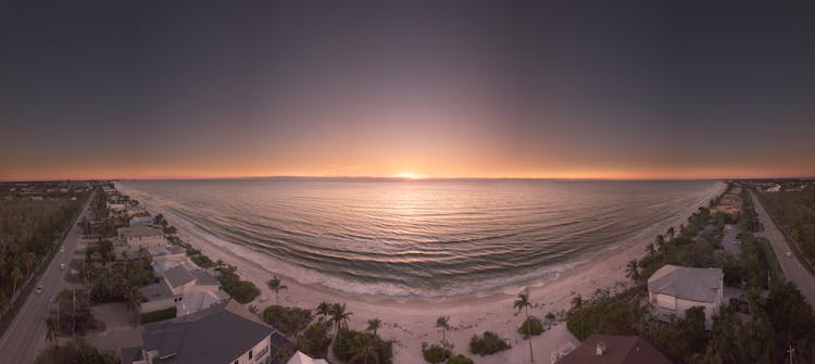 Panoramic Photography Of Beach During Golden Hour