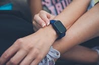 Person Wearing Blue and Black Smart Watch