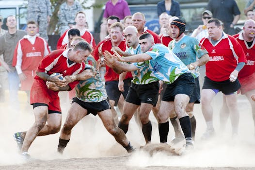 A competitive rugby match showcasing teamwork, athleticism, and dynamic action on a dusty field.