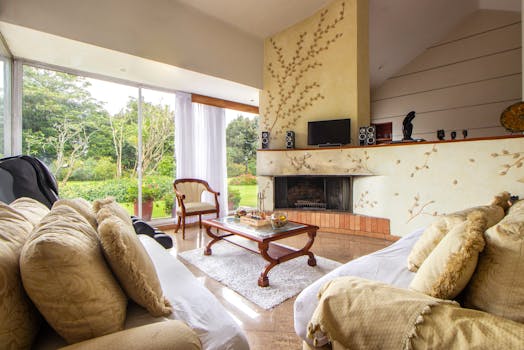 A serene living room with fireplace and garden view, perfect for relaxation.