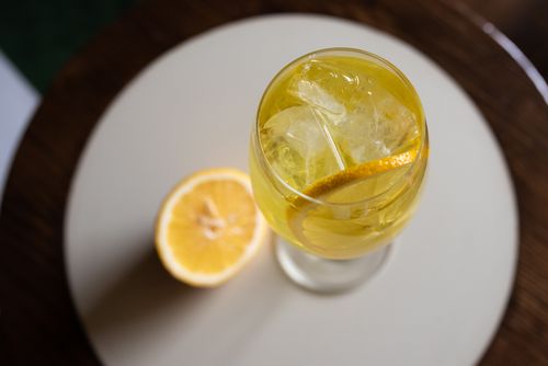 Free Top view of a vibrant cocktail with lemon and ice on a round table. Stock Photo
