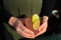 Person Holding Clear Drinking Glass With Orange Juice