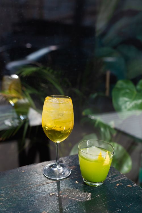 Free Bright yellow and green cocktails on a rustic table, perfect for summer vibes. Stock Photo