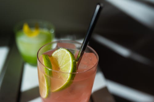 Close-Up Photo of a Pink Alcoholic Drink with a Black Straw