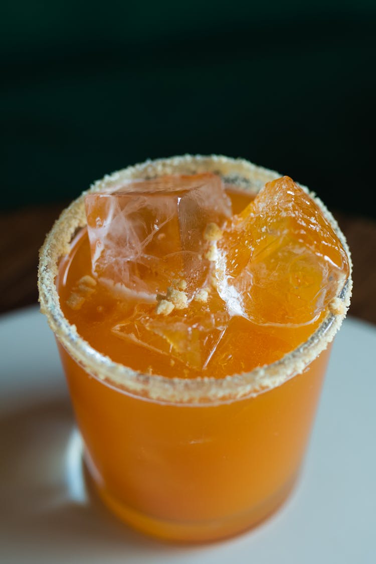 Orange Cocktail With Ice In Glass Rimmed With Salt