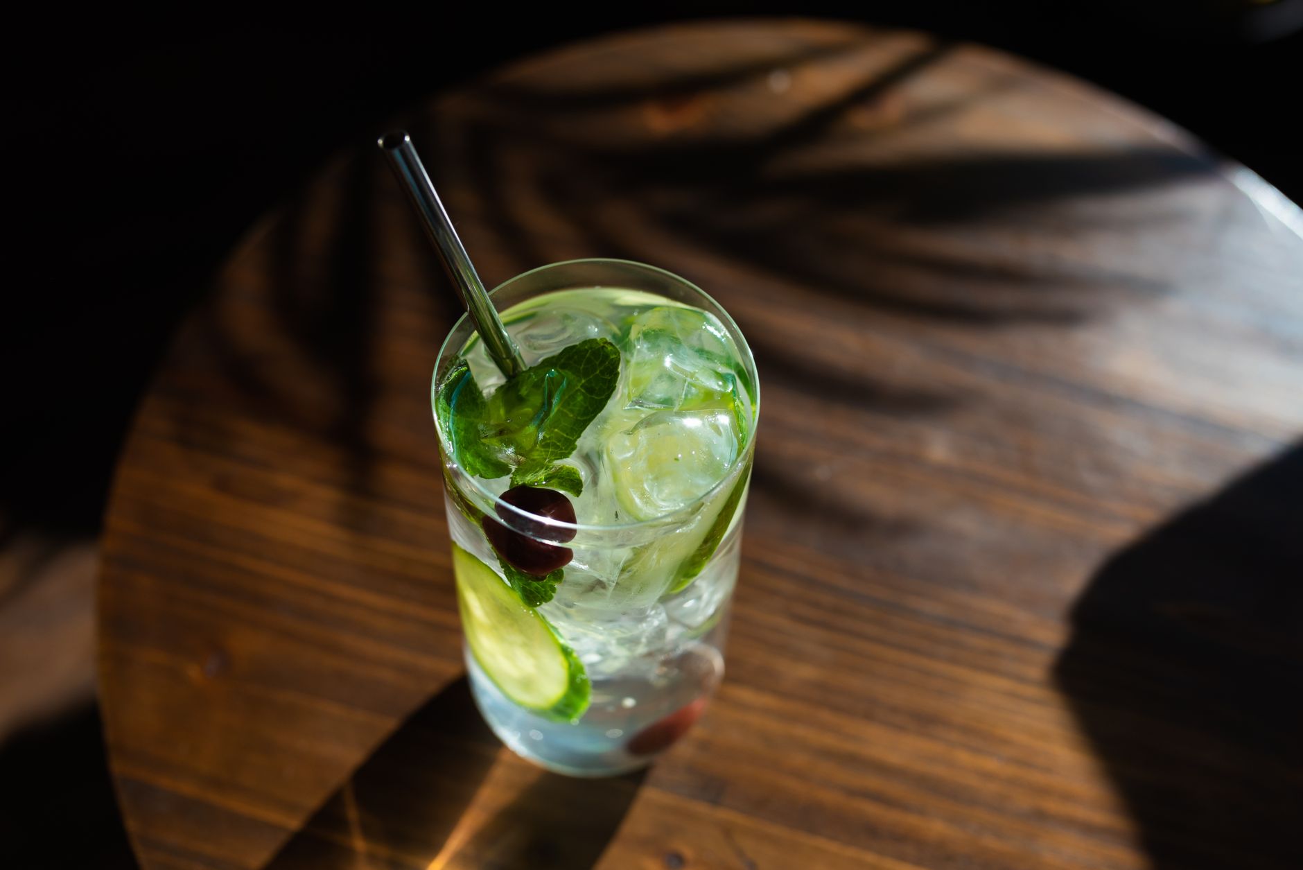 Cocktail shaker with fresh rosemary and cucumber