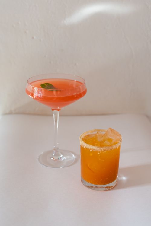 Free Elegant citrus and berry cocktails served on a white surface in stylish glassware. Stock Photo