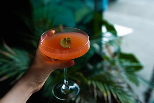 Close-Up Shot of a Person Holding a Cocktail Drink