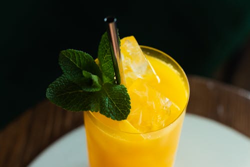 Close-Up Shot of a Cocktail Drink with Mint Leaves on a Glass