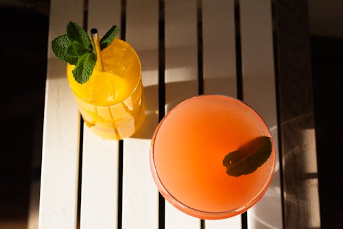 Orange and Yellow Juice in Clear Drinking Glass