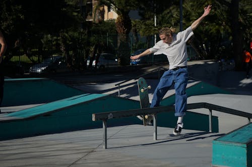 Free Man Doing a Skateboard Trick Stock Photo