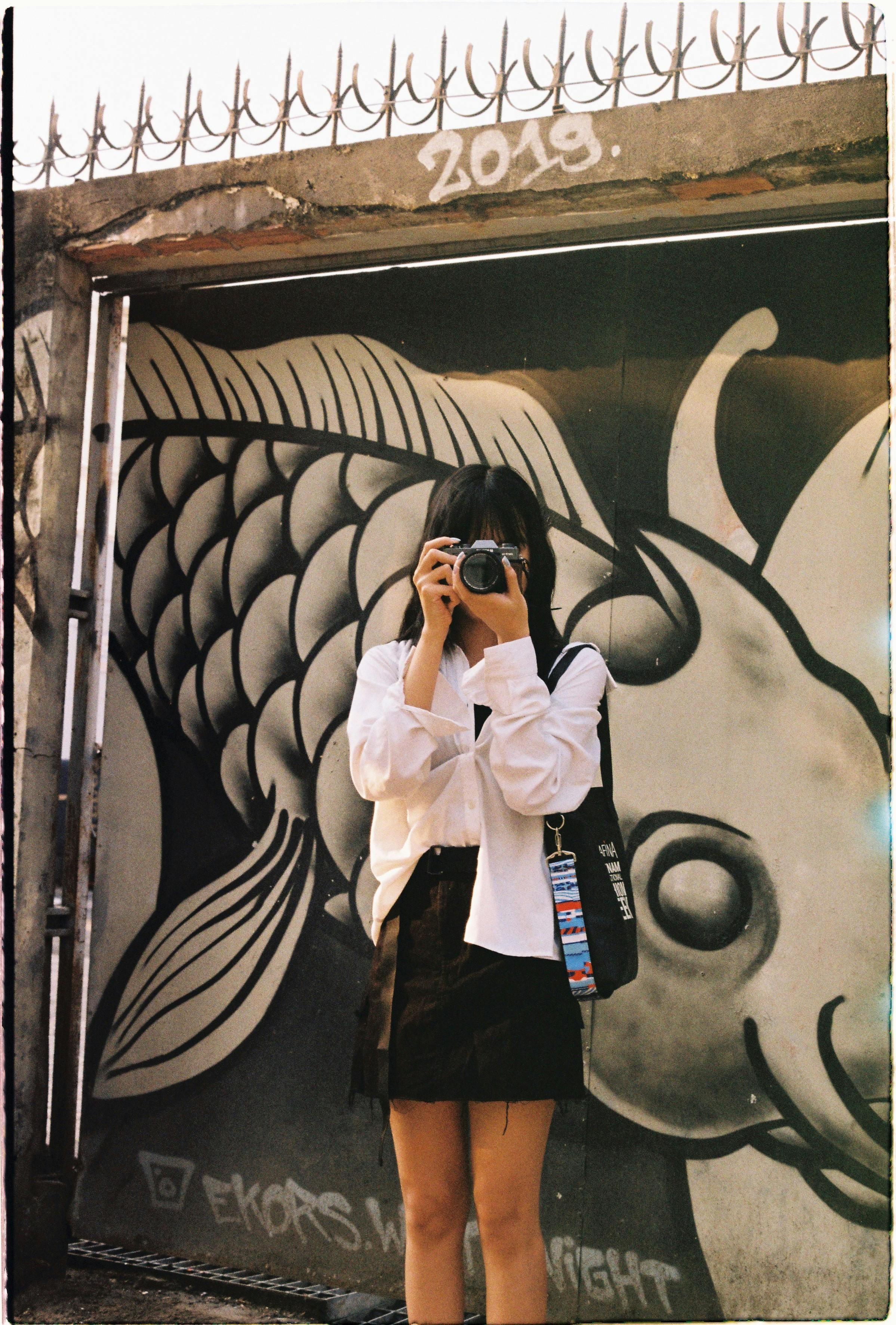 woman taking pictures on the street