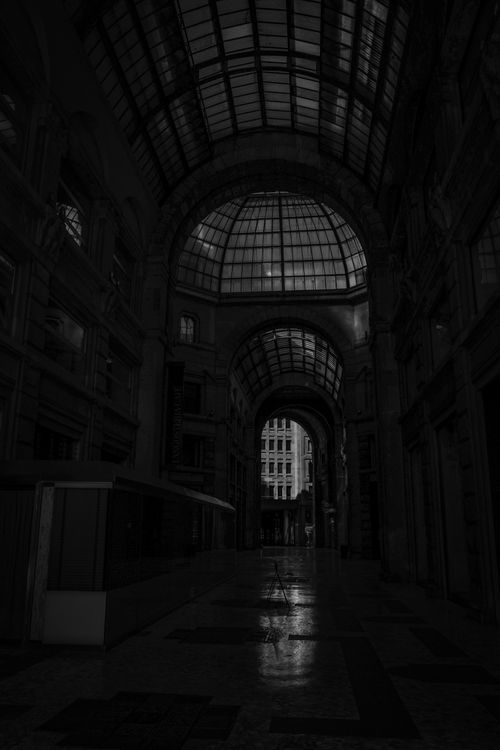 Free Black and white of empty passage of historic building with arched ceiling and glass dome at night Stock Photo