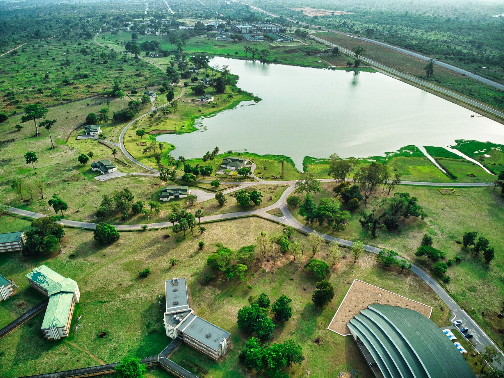 Breathtaking aerial view of a tranquil lakeside landscape in Yamoussoukro, Côte d'Ivoire.