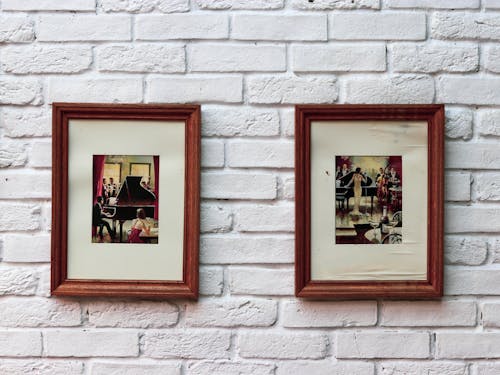 Framed Paintings Hanging on White Wall