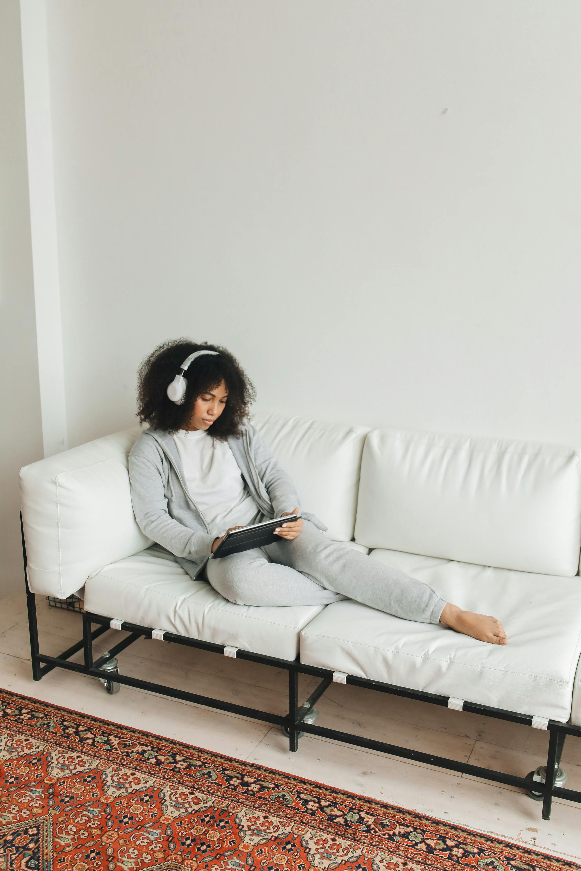 woman in gray sweater sitting on a couch