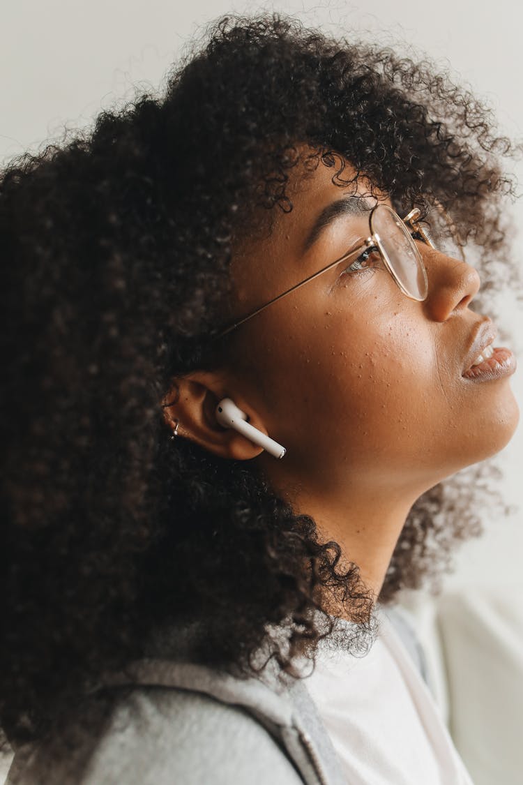 Close-Up Shot Of A Woman Wearing White Earphone