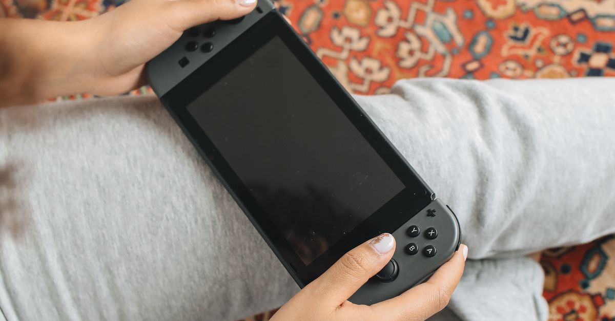Person Holding a Video Game Console · Free Stock Photo