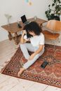 Woman in White T-shirt and Gray Pants Sitting on Floor