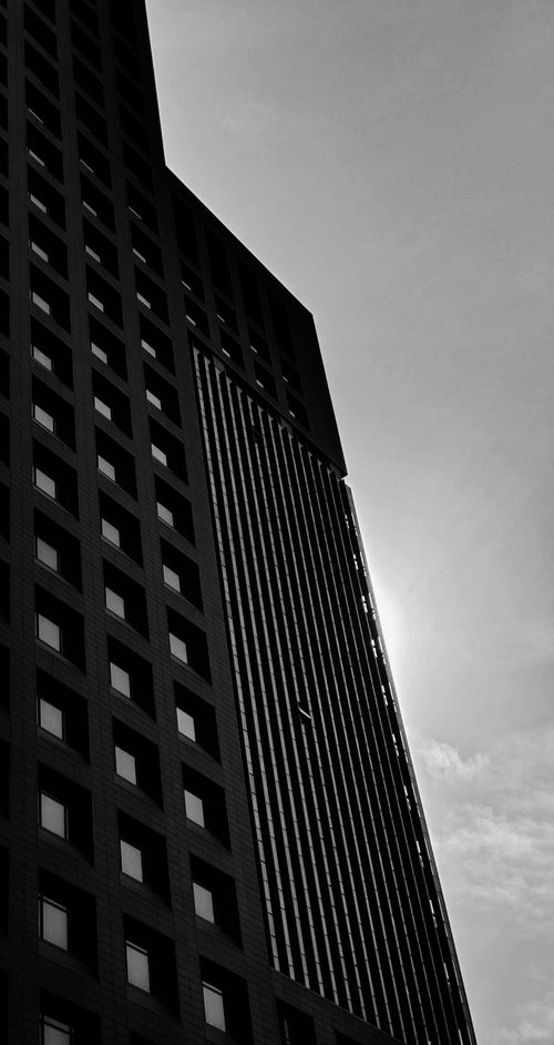 Free A powerful black and white shot of a skyscraper in Beijing with a dramatic low-angle perspective. Stock Photo